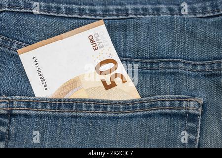 Money in the pocket. Fifty euro note in the pocket of blue jeans Stock Photo