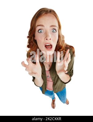 Im terrified. Shot of a young woman looking scared against a white background. Stock Photo