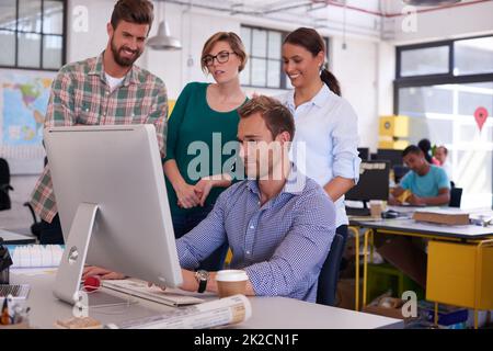 They each have their own ideas. young designers working together in their office. Stock Photo