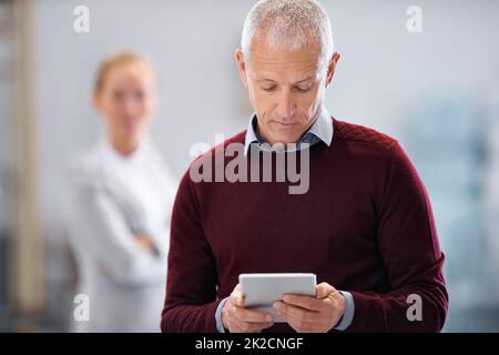 Using technology to streamline production. a male factory manager using a digital tablet during an inspection. Stock Photo