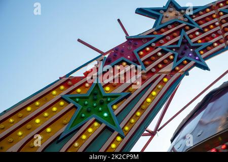 broken stars on old amusement park ride lights colorful bulbs Stock Photo