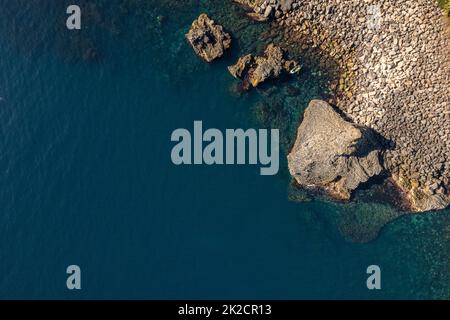 Aerial view of the white volcanic rock formations and sea caves at ...