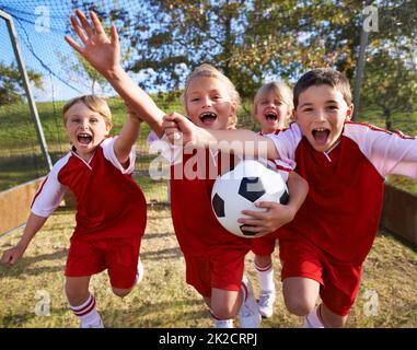 The field holds promise. Shot of a childrens soccer team. Stock Photo