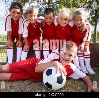 The team photo. Portrait of a childrens soccer team posing for the team photo. Stock Photo