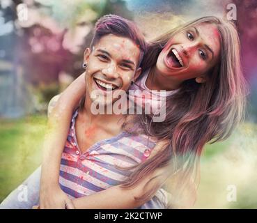 Happiness in color. Shot of happy friends having fun with powder paint. Stock Photo