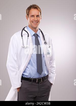 Happy and relaxed after a hard days healing. Cropped studio shot of a relaxed young doctor. Stock Photo