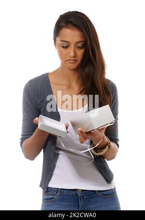 What a let-down.... Disappointed young woman holding an empty gift box against a white background. Stock Photo