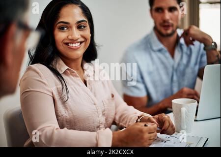 Positivity leads to productivity. Shot of a group of businesspeople having a meeting in a modern office. Stock Photo