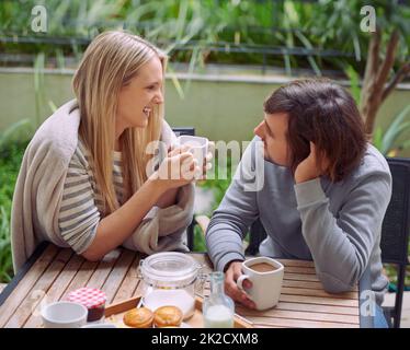 Love is friendship on fire. A happy young couple having coffee together in the morning. Stock Photo