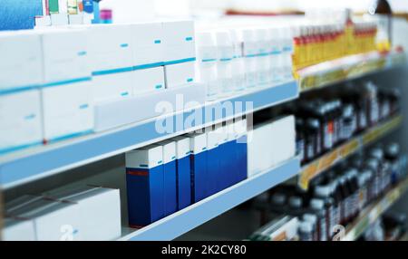 Every brand to get you feeling better. Shot of shelves stocked with various medicinal products in a pharmacy. Stock Photo