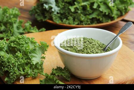 Chopped dry kale leaves on rustic background Stock Photo