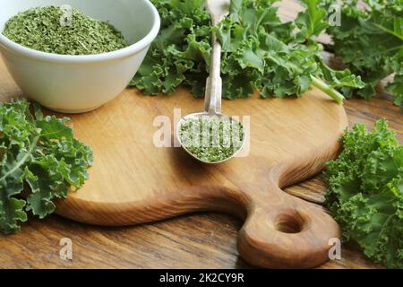 Chopped dry kale leaves on rustic background Stock Photo