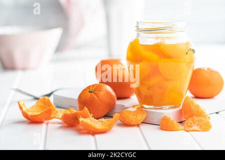 Canned tangerine. Pickled mandarin fruit in jar. Stock Photo