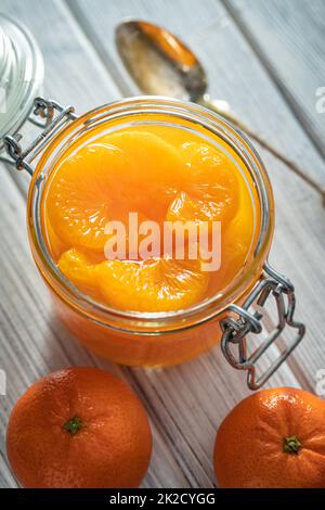 Canned tangerine. Pickled mandarin fruit in jar. Stock Photo