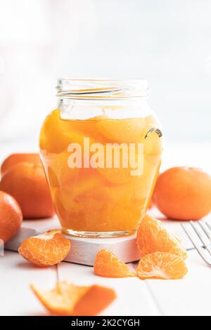 Canned tangerine. Pickled mandarin fruit in jar. Stock Photo