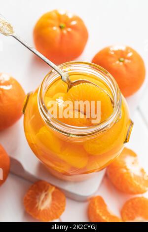 Canned tangerine. Pickled mandarin fruit in jar. Stock Photo