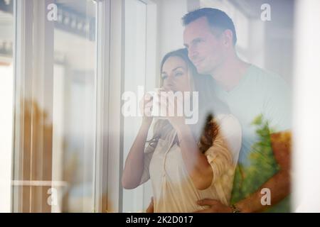 Our mornings are great. Cropped shot of a happily married couple drinking coffee in the morning. Stock Photo