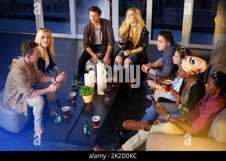 With friends like these, its always a good time. Shot of a group of friends having fun at a nightclub. Stock Photo