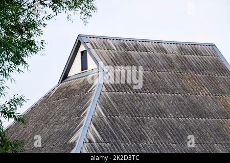 Roof from the old slate. Roof of the house. Corrugated slate Stock Photo