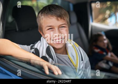 Ready for a road trip. Cropped portrait of a young boy sitting in the car before going on a roadtrip with his family. Stock Photo