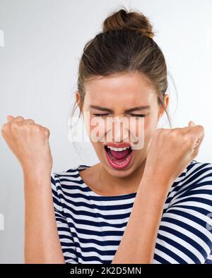 Im awesome Oh yeah. a gorgeous young woman celebrating. Stock Photo