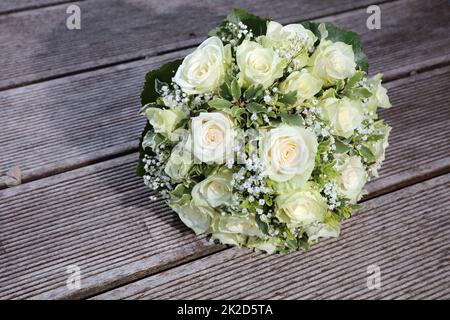 Bridal Bouquet with white Roses on wooden Plank Stock Photo