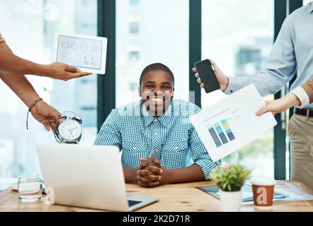 Its important to stay cool, calm, and collected. Shot of a young businessman looking calm in a demanding office environment. Stock Photo