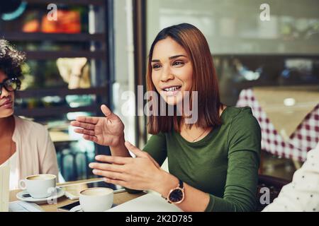 Explaining her point of view over the matter. Cropped shot of designers having a meeting at a coffee shop. Stock Photo