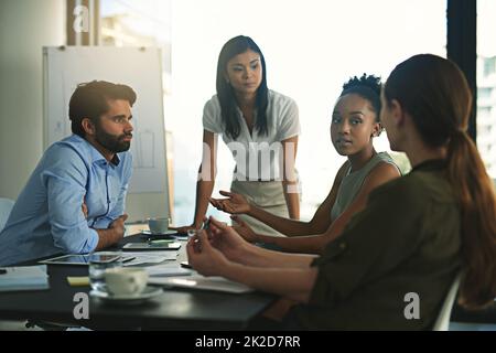 Seriously. Shot of a group of businesspeople meeting in the boardroom. Stock Photo