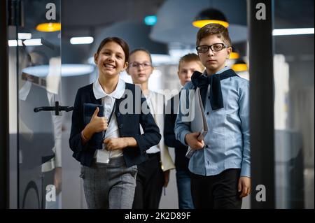 Diverse confident children business group entering office Stock Photo