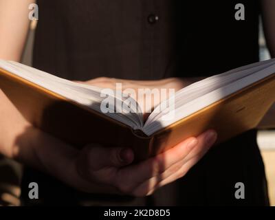 Book in hands close up Stock Photo