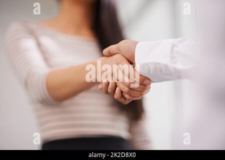 The deal is sealed. Low angle shot of two colleagues shaking hands. Stock Photo