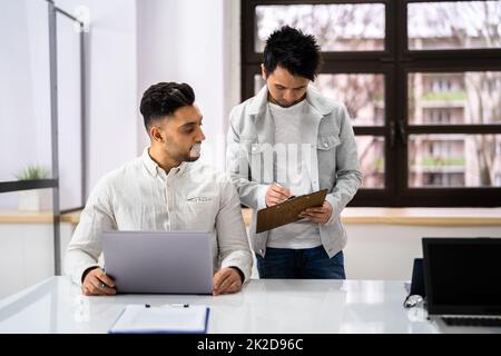Two Happy Young Businesspeople Working On Computer Stock Photo