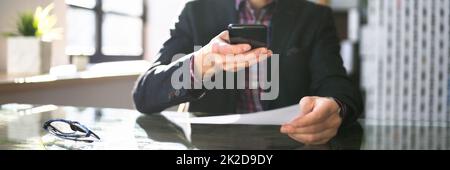 Remote Cheque Deposit Using Mobile Phone Stock Photo