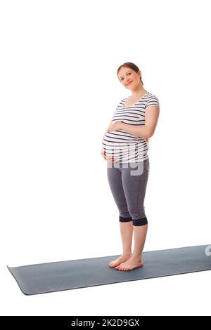 Pregnant woman standing embracing her belly Stock Photo