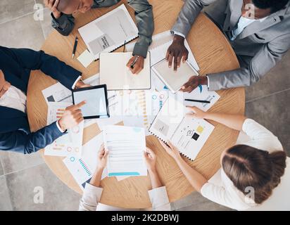 Marketing team with data documents and technology working on a project with graphs, data and tech. Teamwork, paperwork and business people in Stock Photo