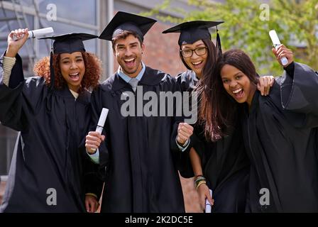 Ecstatic education success. Shot of excited university students on graduation day. Stock Photo