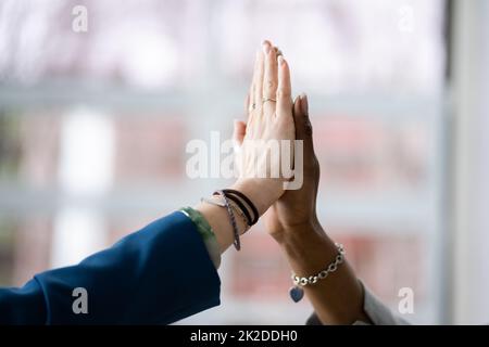 Two Smiling Young Businesswomen Giving High Five Stock Photo