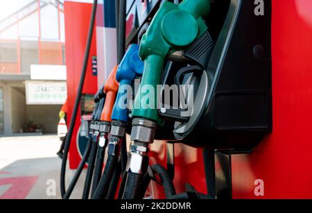 Petrol pump filling fuel nozzle in gas station. Fuel dispenser. Refuel fill up with petrol gasoline. Gas pump handle. Green petrol fuel nozzle. Petroleum oil industry. Oil crisis. Petrol price crisis. Stock Photo