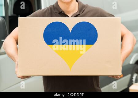 Delivery Man Carrying Box In Hand Stock Photo