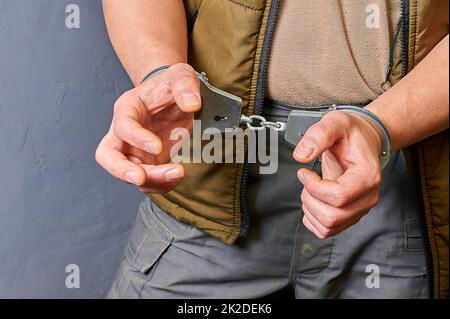 men's hands in metal handcuffs Stock Photo