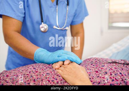 Doctor check Asian elder senior woman patient wearing a mask for protect covid coronavirus. Stock Photo