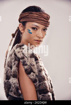 Wear your heritage. Studio portrait of an attractive young native american styled woman. Stock Photo
