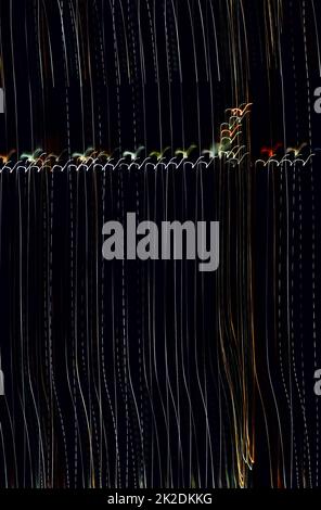 Light streaks on a dark night backdrop. Stock Photo
