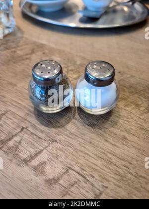 Salt and pepper shaker on old table top taken from above. Stock Photo