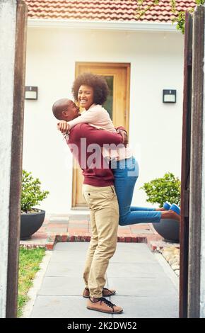 This is another big milestone for us. Shot of a young couple celebrating the move into their new house. Stock Photo