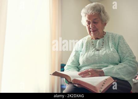 Faith is the strongest pillar of strength. Cropped shot of a senior woman reading a bible. Stock Photo