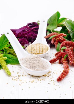 Flour and seeds amaranth in spoons on board Stock Photo