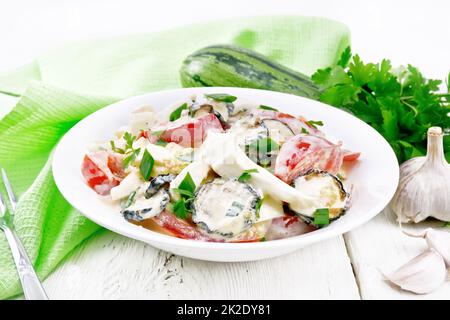 Salad with fried zucchini in plate on board Stock Photo