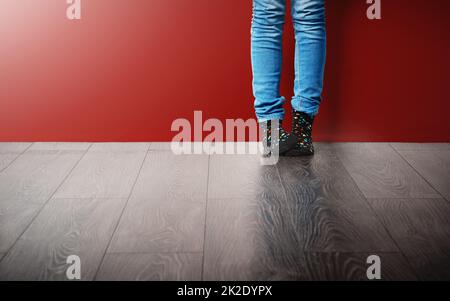 Cosy socks inspire happy feet. Cropped studio shot of a woman wearing jeans and socks. Stock Photo